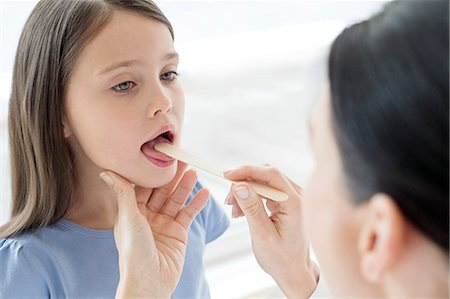 679-09022215
© Masterfile Royalty-Free
Model Release: Yes
Property Release: No
Female doctor examining inside girl's mouth.